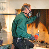 A chimney sweep cleans chimney & fireplace at home on Chestnut Hill Rd Glastonbury CT